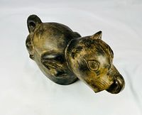 Three-quarter view showing dog form and stirrup spout