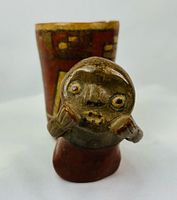Front view showing cup and attached anthropomorphic figure