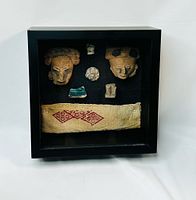 Full view of shadowbox showing all artifacts mounted inside frame