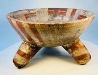 Oblique view showing full bowl on three legs, painted stripes visible