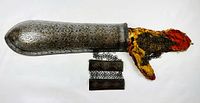 Full view of arm guard with attached chain mail and red fabric interior