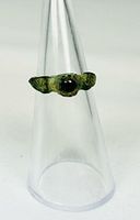 Front view of bronze ring displaying garnet cabochon and patina
