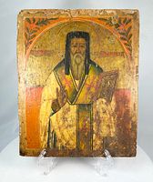 Front view of Russian icon showing saint, colors, gold leaf, wear