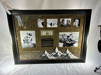 Overall view of framed display showing banknote, photos, title and mountain graphic
