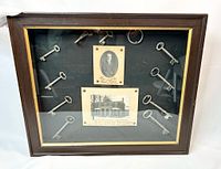 Front view of framed shadowbox showing keys and photographs