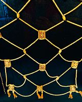 Full apron showing lattice of bone beads and plaques