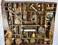 Full frontal view of wooden shadow box showing all compartments and contents.