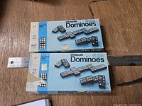 Two Dragon Dominoes boxed sets side by side with rulers for scale