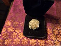 Ring in box showing floral filigree face