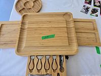 Top view of board with side trays extended, round tray visible, green tape number