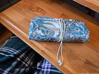 Jewelry roll folded and tied with cord