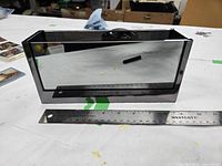 Front view displaying mirrored glass side and overall rectangular shape