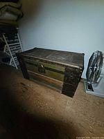 Closed trunk showing exterior wood, canvas panels, metal trim and hardware
