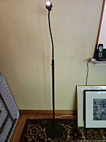 Full view of black metal floor lamp illuminated