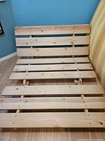 Natural wood full-size slatted bed frame with headboard