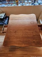 Table top with both drawers open showing wood grain and wear