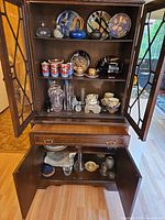 Cabinet open showing interior shelves and storage compartments