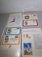 Four album pages showing Le Petit Prince, generic FDC, Aéro-Club de France, Elvis Presley in plastic sleeves
