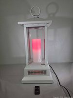 Front view of white Duraflame lantern heater showing LED flame and power cord