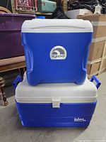 Two stacked Igloo coolers, exterior view showing size difference and logos