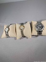 All three wristwatches on pillows