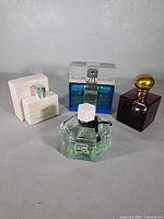 All four perfume bottles grouped together on surface