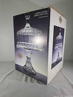 Front of box displaying image of domed cake stand