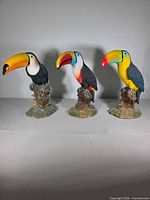 Front view of all three toucan figurines