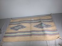 Front view of woven wool rug showing pattern and colors