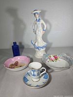 Group shot showing all porcelain pieces and cobalt bottle