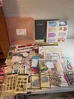 Entire lot laid out showing container, album, paper pads, adhesive and embellishment packs