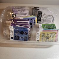 Overview of multiple sealed stamp packs in plastic bin