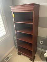 Full front view of bookcase showing four shelves and base