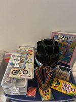 Group shot of organizer, pencils, cards, colouring book, storage drawers