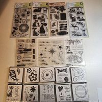All seven clear stamp sets and ten wood stamps arranged