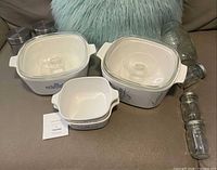 Group view of casserole dishes, jars and mug