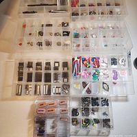 Overview of nine plastic organizers with assorted embellishments