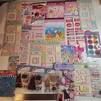Variety of roughly 25 sticker packs laid out together