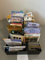 Front view of organizer showing many sealed embellishment packs