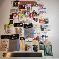 All packages of embellishments laid out with ruler for scale