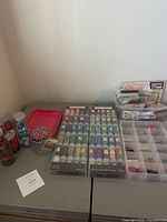 Full lot on table showing microbead trays, jars, organizer, stickers, tray and wire ball