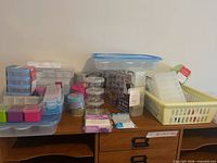 Multiple small storage containers on desk