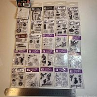 All 25 sealed Studio G clear stamp packs laid out