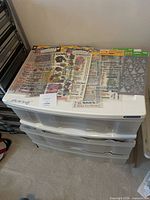 Plastic three-drawer unit with sticker sheets on top