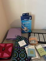 Group shot showing hand tool box, storage albums, die packages, plastic case