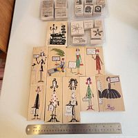 Front view of all 26 stamps arranged on table with ruler