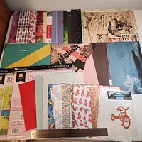 Assorted scrapbook paper laid out with ruler for scale