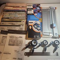 Full lot overview with paper stack, punches, trimmer, ruler, blade pack