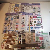 Front view of all 26 sticker packs with ruler for scale