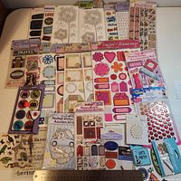 Full lot laid out showing all sticker packs including tags, florals, labels, chipboard, enamel dots